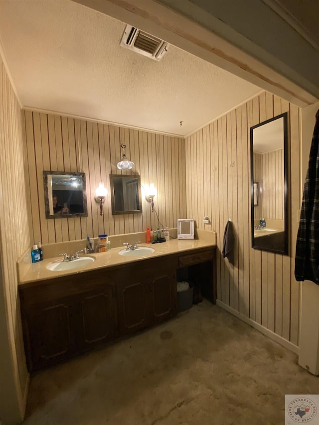 bathroom with vanity and wood walls