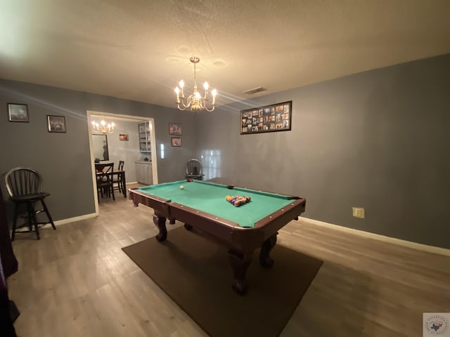 playroom featuring billiards, hardwood / wood-style floors, and an inviting chandelier