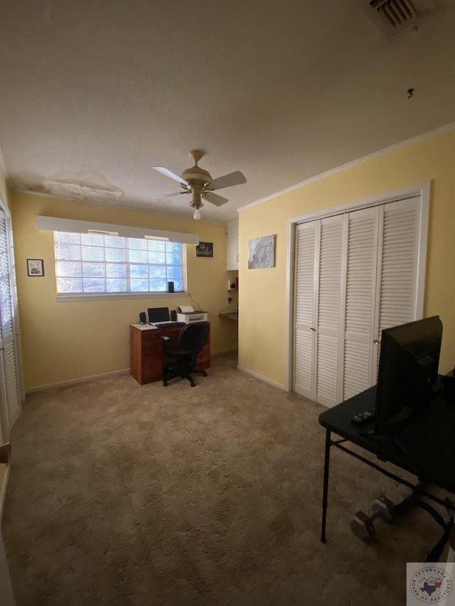 home office with carpet floors, crown molding, and ceiling fan