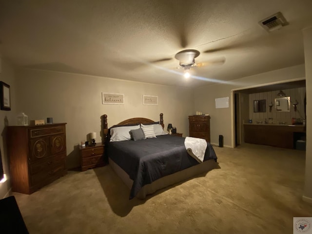 carpeted bedroom with a textured ceiling and ceiling fan