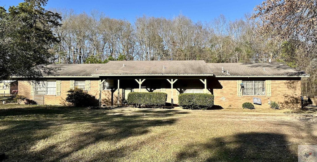 rear view of property with a yard