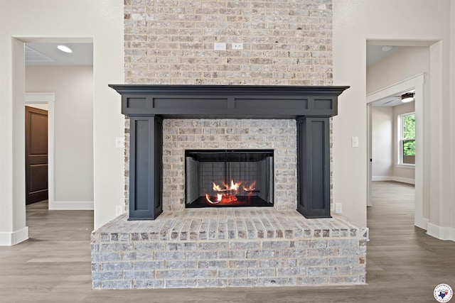 8405 Mandarin Cv, Texarkana, TX 75503 - room details with baseboards, wood finished floors, a ceiling fan, and a fireplace