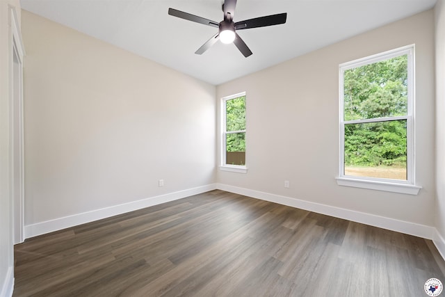 8405 Mandarin Cv, Texarkana, TX 75503 - unfurnished room with dark wood-style flooring, ceiling fan, and baseboards