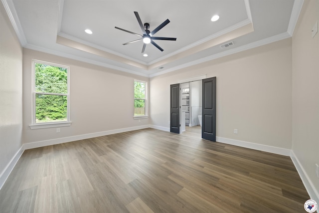 8405 Mandarin Cv, Texarkana, TX 75503 - unfurnished bedroom featuring ornamental molding, a tray ceiling, and multiple windows