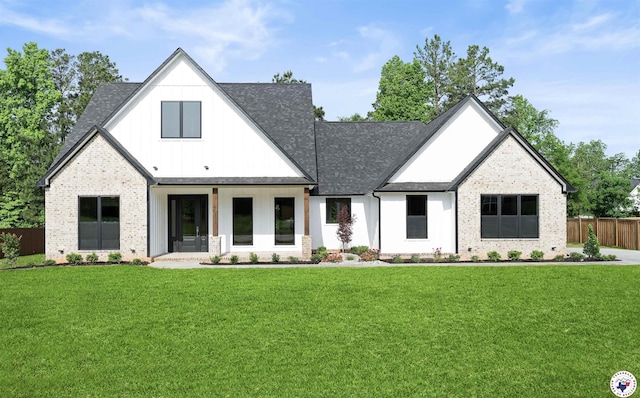 8405 Mandarin Cv, Texarkana, TX 75503 - modern farmhouse with a front yard, fence, a shingled roof, and brick siding