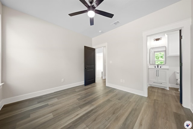 8405 Mandarin Cv, Texarkana, TX 75503 - unfurnished bedroom featuring wood finished floors, visible vents, connected bathroom, and baseboards