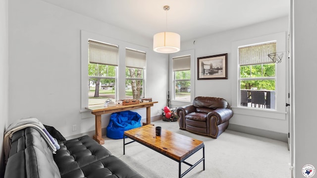 carpeted living room with baseboards