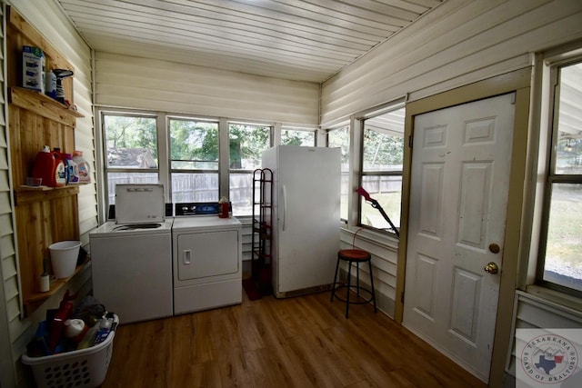 laundry area with separate washer and dryer and wood-type flooring