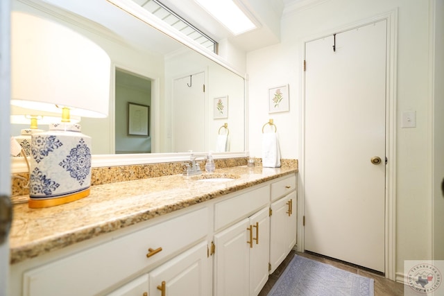 bathroom featuring ornamental molding, tile patterned flooring, and vanity