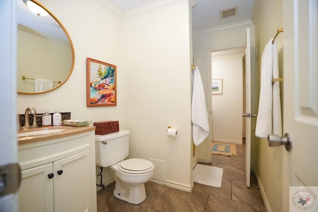 bathroom featuring vanity, toilet, crown molding, and tile patterned floors