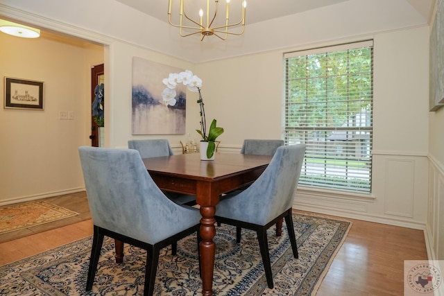 dining area featuring hardwood / wood-style flooring and a chandelier