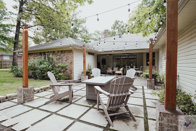 view of patio featuring an outdoor living space with a fire pit