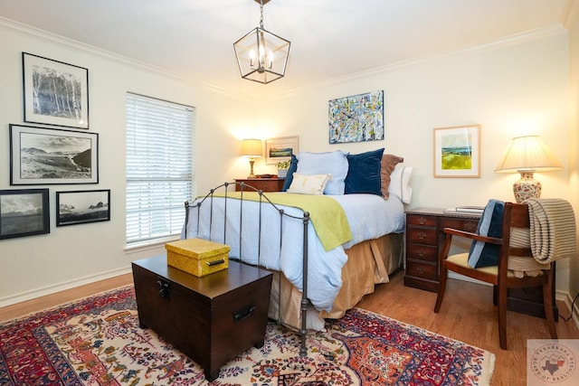 bedroom featuring crown molding, light wood-type flooring, and a chandelier