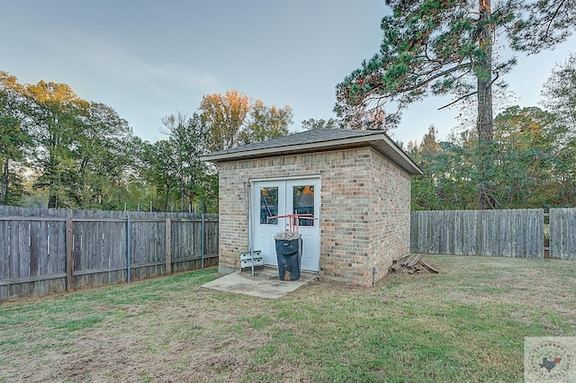 view of outbuilding featuring a lawn