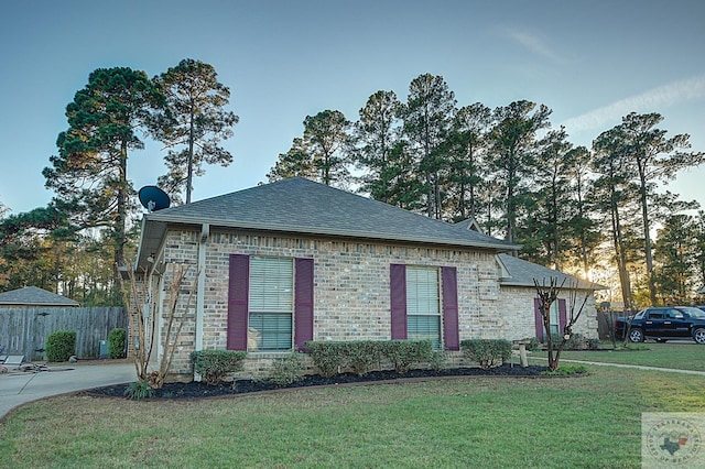 property exterior at dusk with a yard