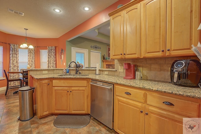 kitchen with light stone countertops, tasteful backsplash, sink, kitchen peninsula, and stainless steel dishwasher