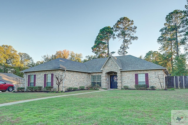 french country inspired facade featuring a front yard