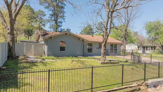 rear view of property with a lawn