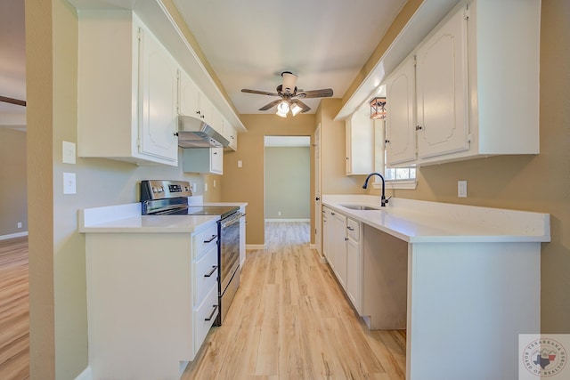 kitchen with white cabinetry, sink, ceiling fan, electric range, and light hardwood / wood-style flooring