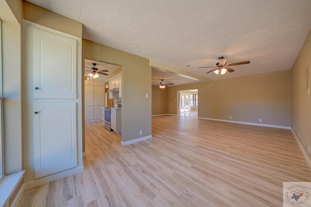 unfurnished living room with ceiling fan, light hardwood / wood-style floors, and a textured ceiling