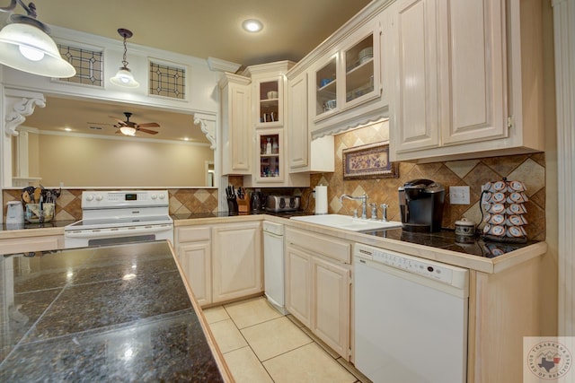 kitchen with pendant lighting, white appliances, sink, backsplash, and light tile patterned flooring