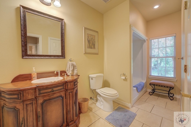 bathroom featuring tile patterned floors, vanity, and toilet