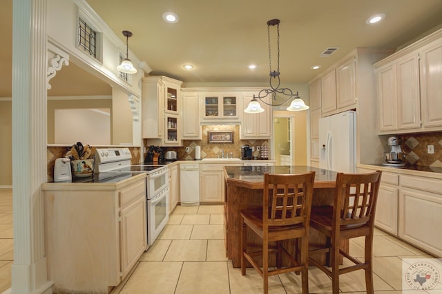 kitchen featuring white appliances, pendant lighting, a breakfast bar, and light tile patterned floors