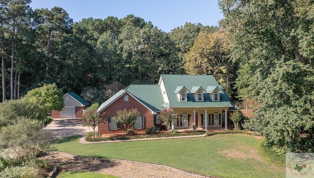 cape cod home featuring a garage, a front lawn, a porch, and an outbuilding