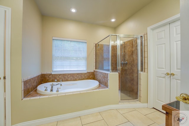 bathroom with shower with separate bathtub and tile patterned flooring