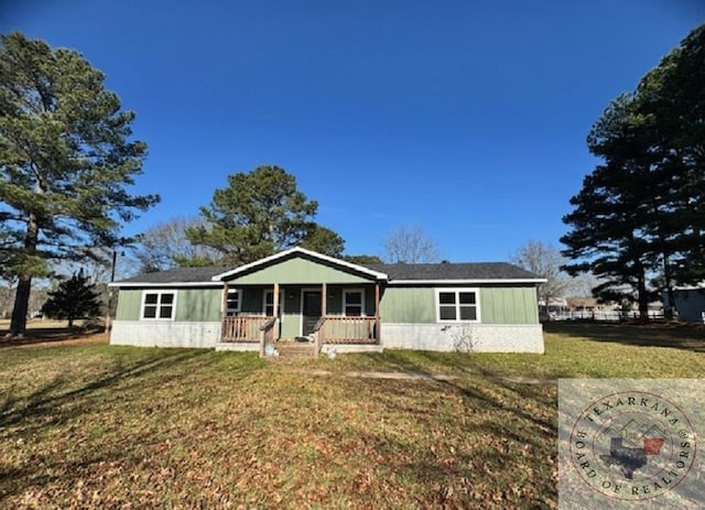 single story home featuring covered porch and a front yard