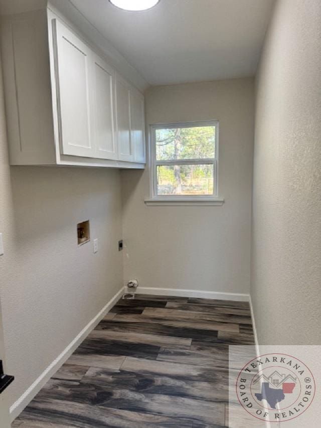 laundry room with hookup for an electric dryer, cabinets, washer hookup, and dark wood-type flooring