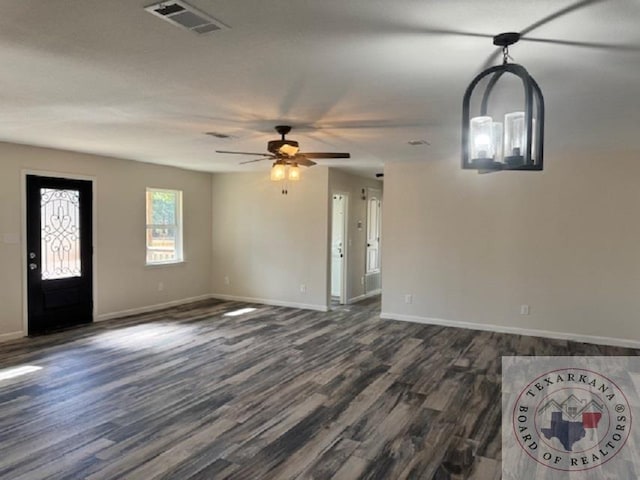 unfurnished living room featuring ceiling fan and dark hardwood / wood-style flooring