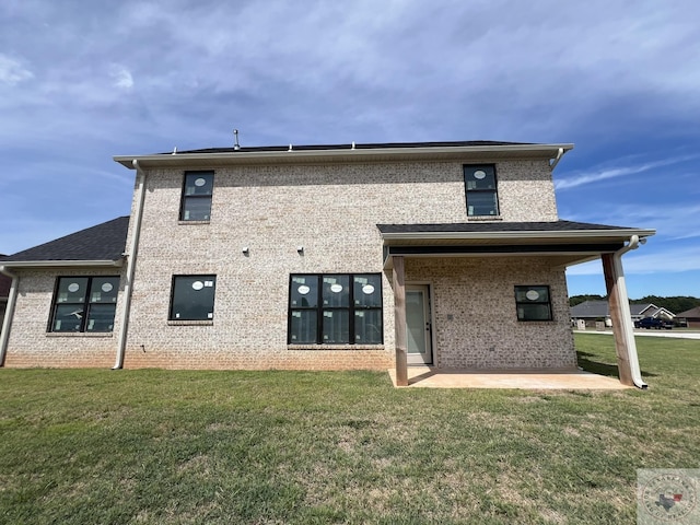 rear view of property featuring a patio area and a yard