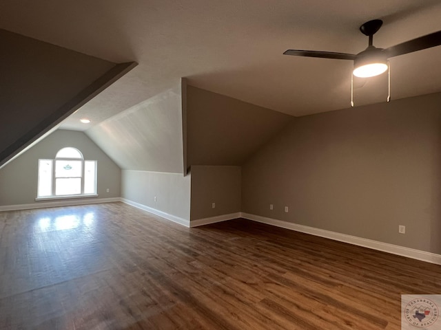 additional living space with ceiling fan, dark hardwood / wood-style floors, and vaulted ceiling