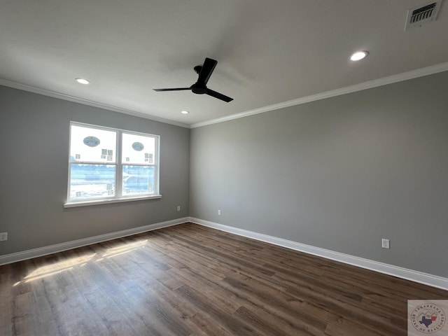 empty room with ceiling fan, dark hardwood / wood-style flooring, and crown molding