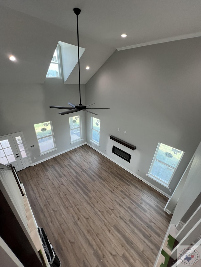 unfurnished living room with vaulted ceiling, ceiling fan, and hardwood / wood-style flooring