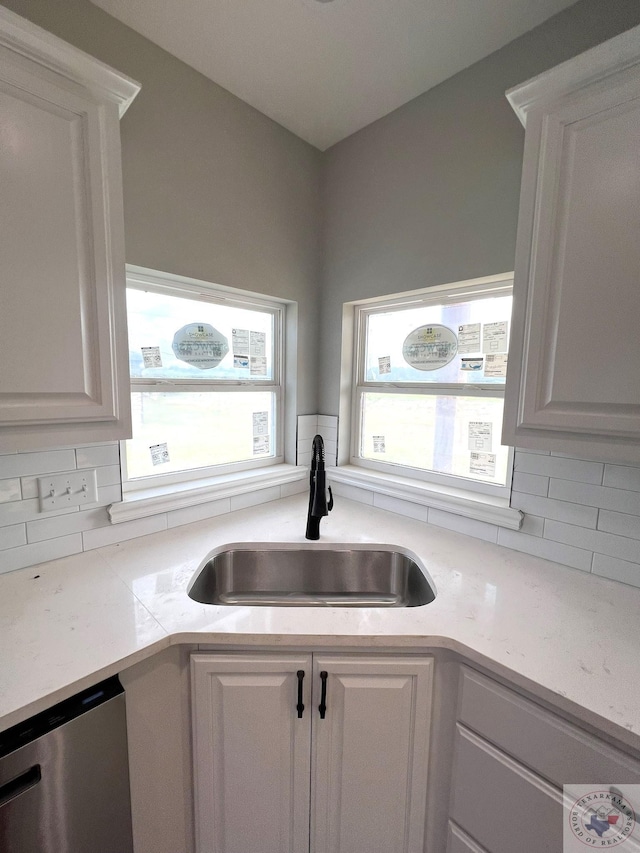 kitchen featuring sink, a wealth of natural light, white cabinets, and dishwasher