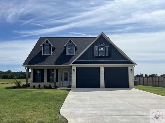 view of front of home featuring a front yard, a porch, and a garage