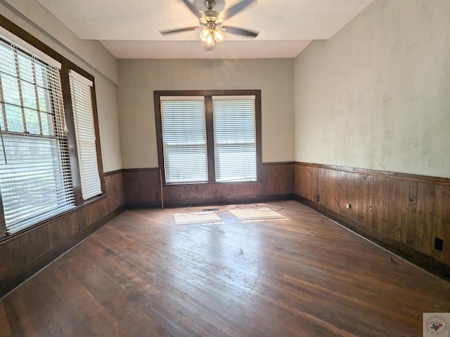 spare room featuring ceiling fan and dark wood-type flooring