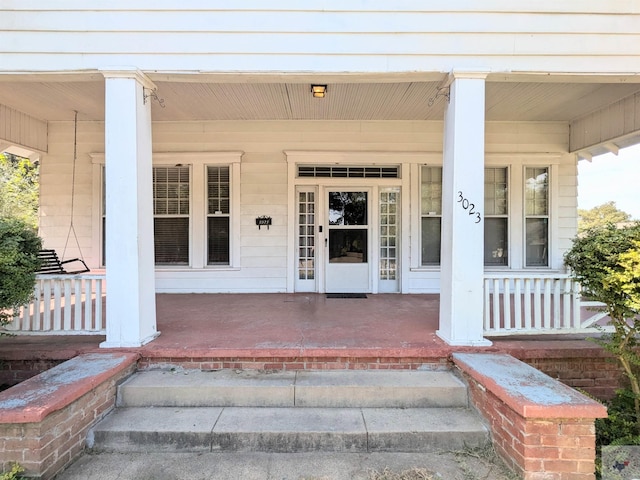 view of exterior entry with covered porch