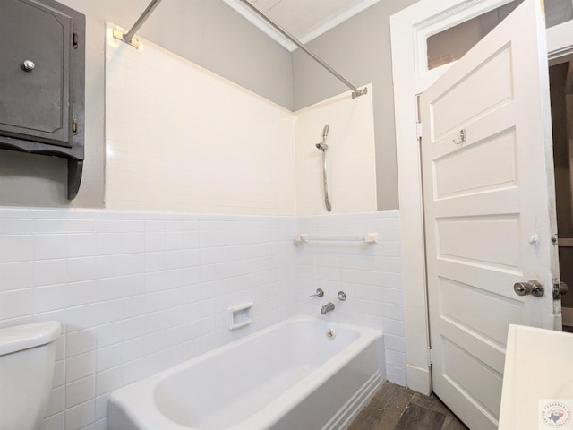 bathroom featuring toilet, shower / bath combination, tile walls, and hardwood / wood-style floors