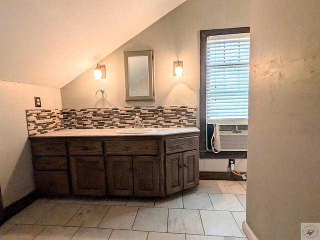 bathroom with cooling unit, vaulted ceiling, tile patterned floors, and vanity