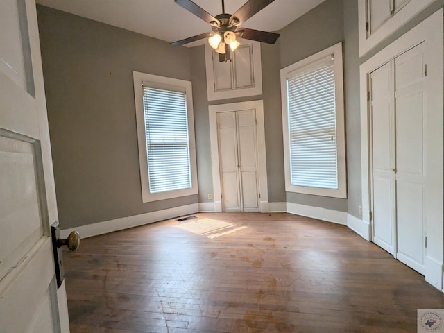 unfurnished bedroom featuring hardwood / wood-style floors and ceiling fan