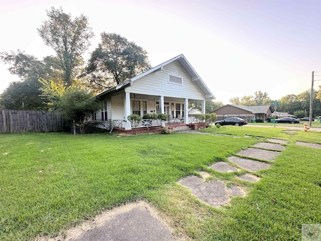 view of front of property with a front yard and a porch