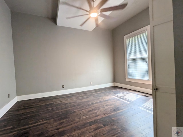 empty room with ceiling fan and dark wood-type flooring