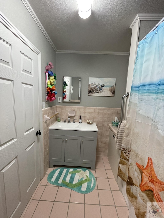 bathroom with ornamental molding, tile patterned flooring, and tile walls