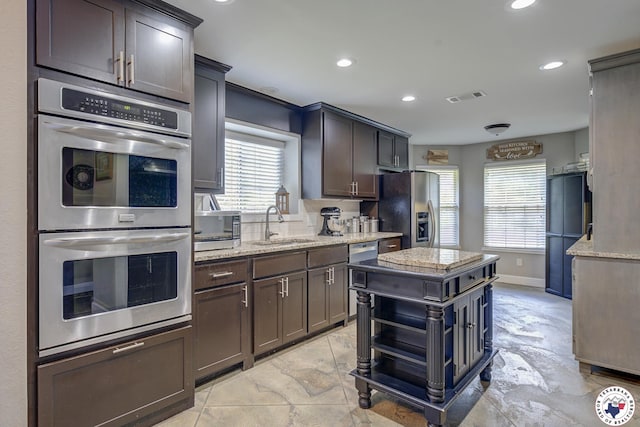 13 Timberlane St, Texarkana, TX 75501 - kitchen with stainless steel appliances, recessed lighting, light stone countertops, a kitchen island, and open shelves