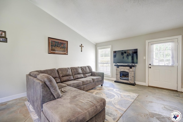 13 Timberlane St, Texarkana, TX 75501 - living area with lofted ceiling, a stone fireplace, and concrete flooring