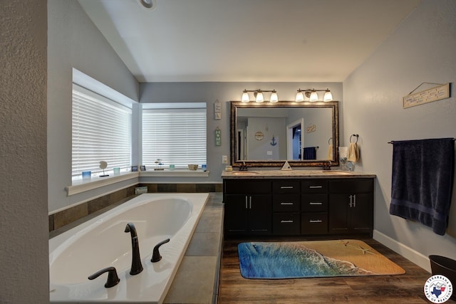 13 Timberlane St, Texarkana, TX 75501 - full bath featuring double vanity, a garden tub, lofted ceiling, and wood finished floors