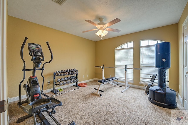 workout area with ceiling fan, a textured ceiling, and carpet